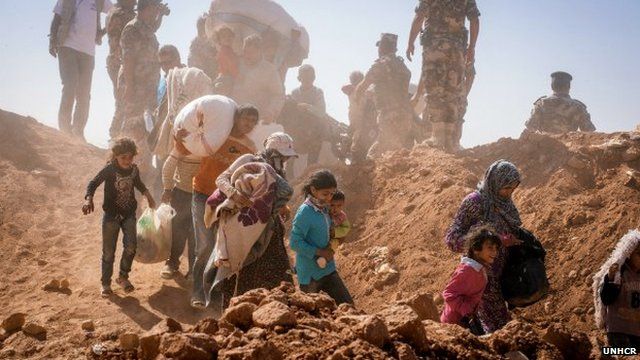 Hundreds of Syrian refugees stream across the border into Jordan at a remote border point in the east