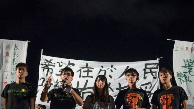 Activists speak at a protest following the ruling
