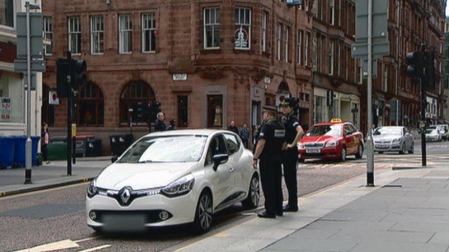 Police stop a driver in a bus lane