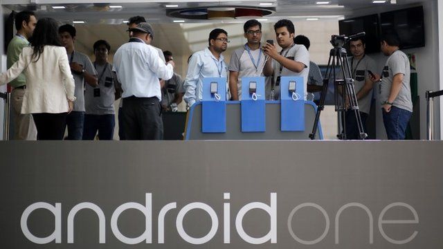 Visitors look at Android One-based mobiles after its launch in New Delhi