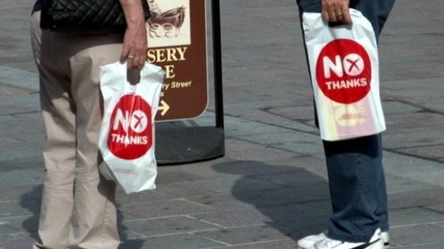 People carrying 'No thanks' bags