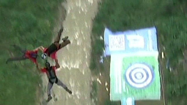 Three base jumpers, having launched from the bridge, falling together