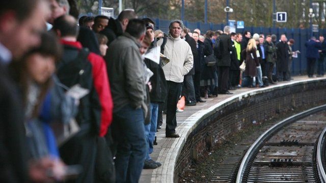 Passengers wait on platform