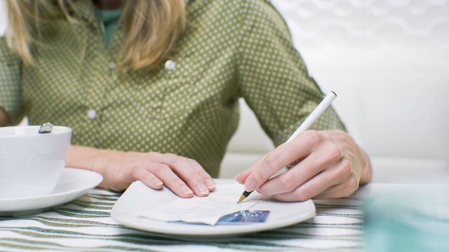 woman signing check