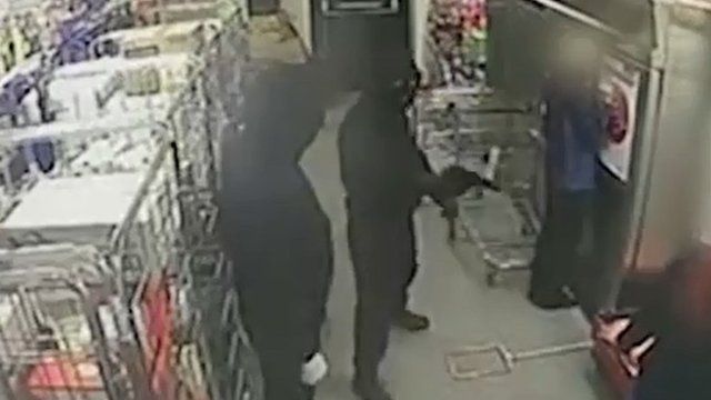Robber points gun at shop worker