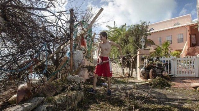 Man cleaning up after Hurricane Gonzalo