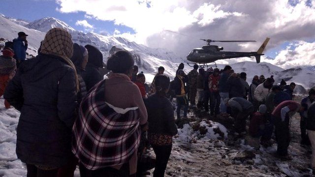 People gathering near a helicopter belonging to Nepal Army