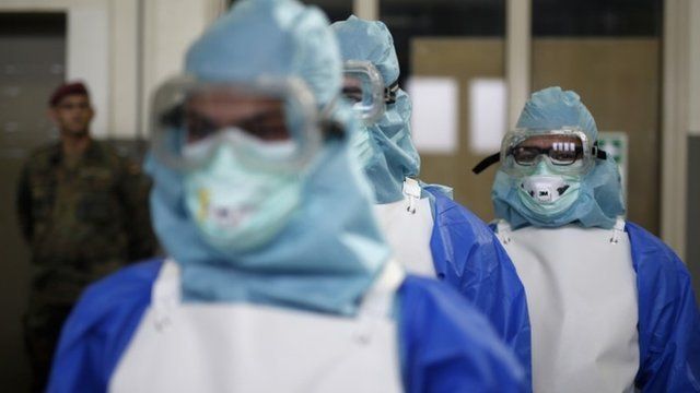 Ebola volunteers in isolation suits