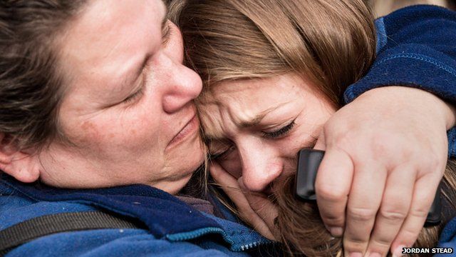 A tearful Marysville Pilchuck High School senior, Cassandra LaBrake, right, is safely reunited with her mother Shellie LaBrake, left, near the scene of the school shooting at Pilchuck High School in Marysville