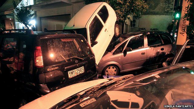 Piled up vehicles in a street in Athens, Greece, after torrential rain caused flash flooding