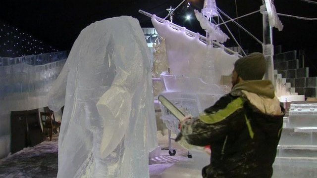 A man sculpts a statue out of ice