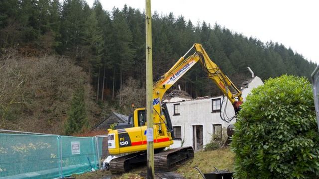 Mark Bridger's cottage in Machynlleth is demolished by a bulldozer