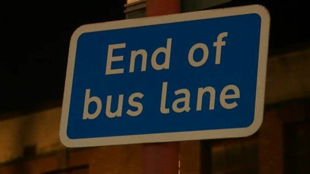 A sign on a bus lane
