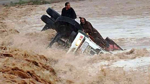 People on an overturned truck in Morocco