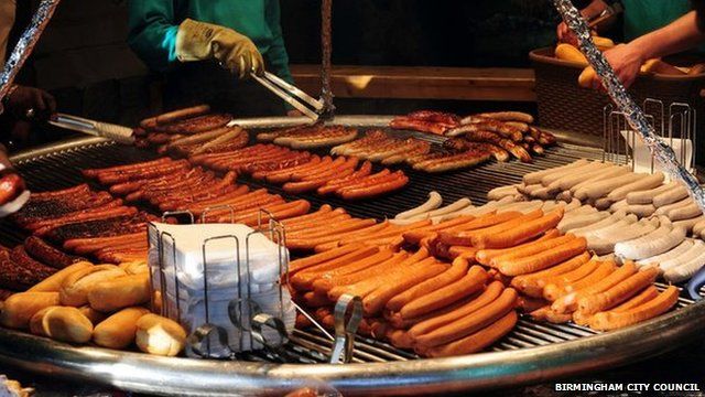 Market staff prepare Bratwurst