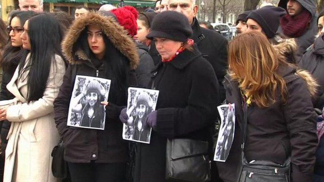 People holding pictures of Tugce Albayrak