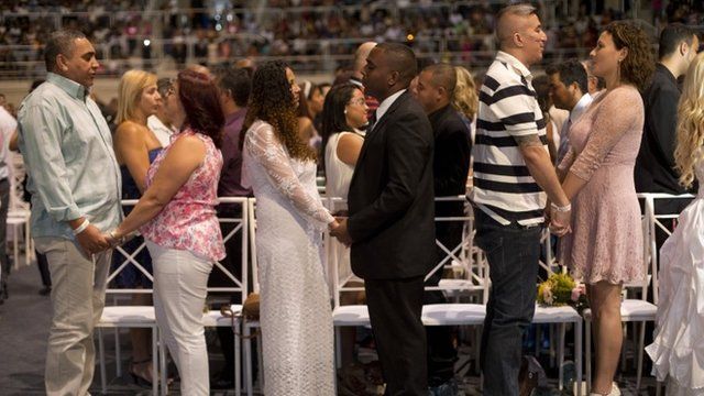 Couples marry during a massive wedding ceremony at the Maracanazinho gymnasium, in Rio de Janeiro, Brazil