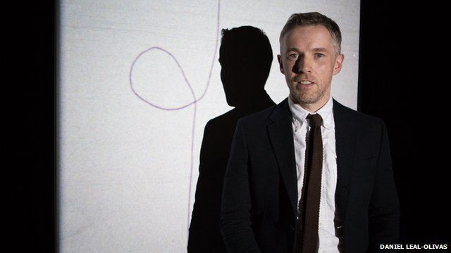Turner prize-winner Duncan Campbell poses in front of his work