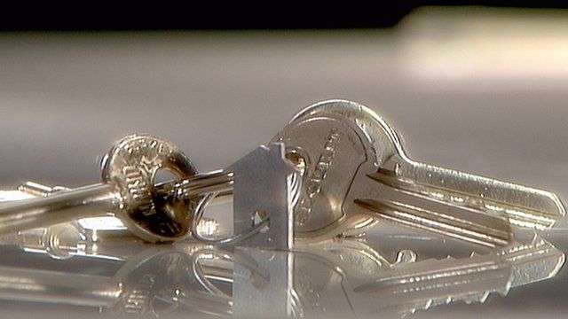 Close up of keys with key ring in shape of a house