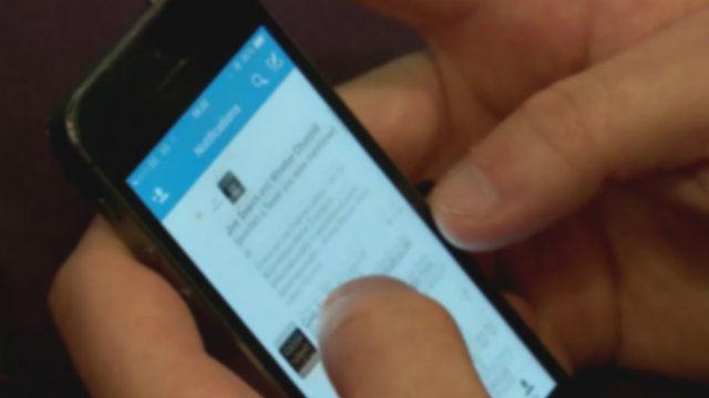 Close up of hands holding mobile phone