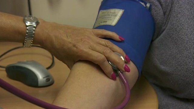Doctor checking patient's blood pressure