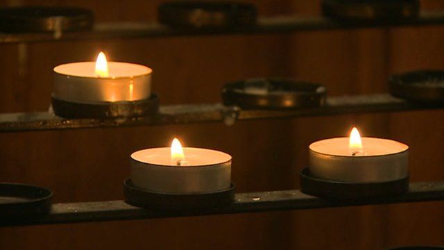 Candles lit at the service for Cameron Comey