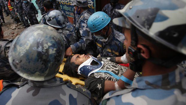 The teenage boy is carried on a stretcher to hospital.