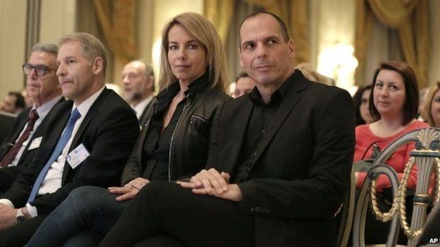 Greek Finance Minister Yanis Varoufakis, right, attends with his wife his wife Danae Stratou a banking conference in Athens, Tuesday, April 21, 2015.