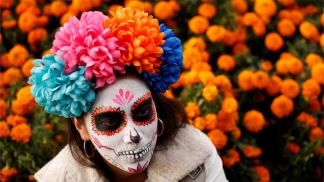 A woman dressed up as Catrina takes part in a Catrinas parade in Mexico City on 22 October 2017