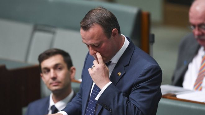 Tim Wilson reaches for a tear during his speech in parliament