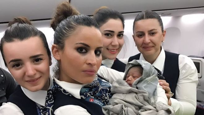 Turkish Airlines stewards with baby Kadiju