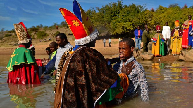 A man is baptised by priests from the Sion church in Mbashe river near Mvezo on June 29, 2013.