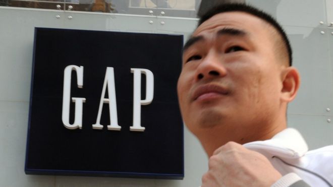 Man walks past Gap store in China