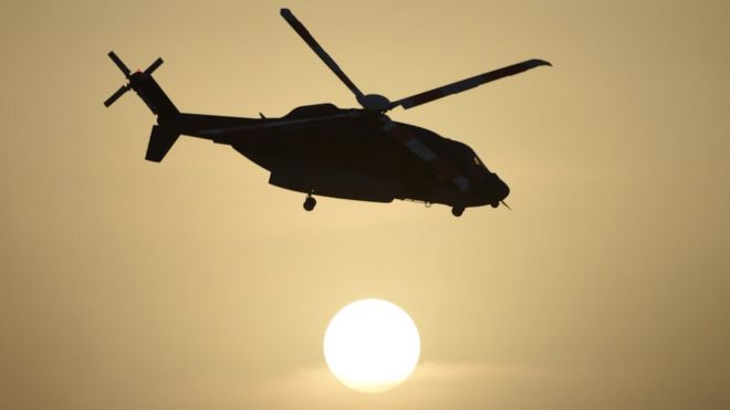 A Saudi special forces helicopter in silhouette against the sun, pictured flying during a graduation ceremony for new soldiers in May 2015