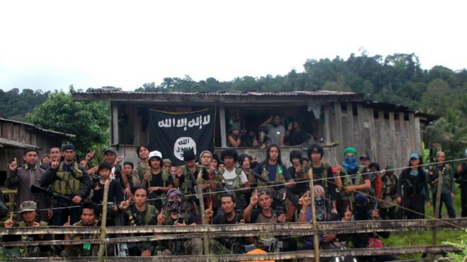 Group of Abu Sayyaf fighters with an Islamic State flag