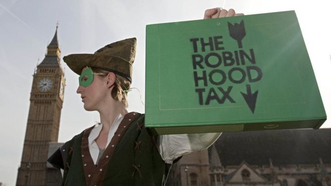 Campaigner for so-called Robin Hood tax, dressed as Robin Hood, stands outside parliament, 2010