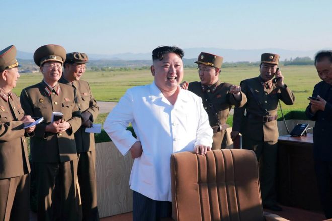 North Korean leader Kim Jong-un watches the test of a new-type anti-aircraft guided weapon system organised by the Academy of National Defence Science in this undated photo released by North Korea's Korean Central News Agency