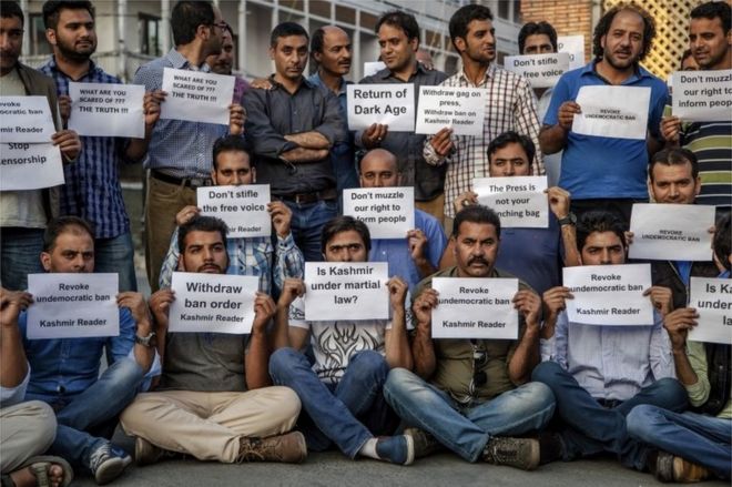 Kashmiri journalists hold placards during a protest in Srinagar, Indian controlled Kashmir, Tuesday, Oct. 4, 2016.