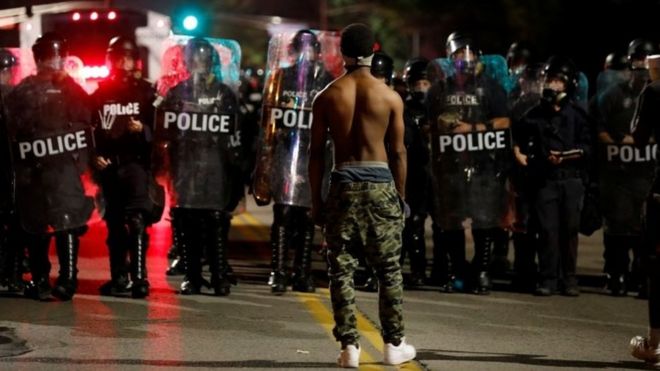 A protester faces off with law enforcement officials after Jason Stockley's acquittal (15 September 2017)