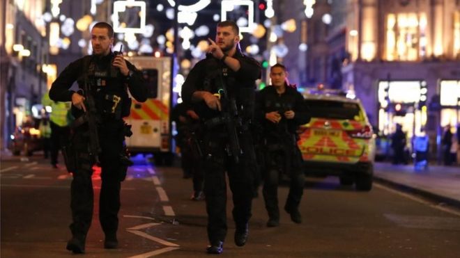 Armed police patrol along Oxford Street