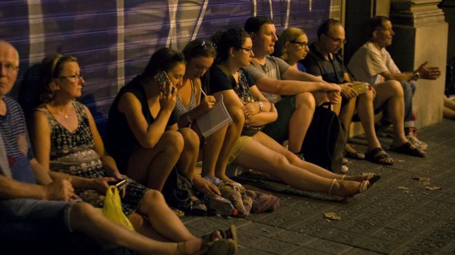 People wait to enter the area after a van crashed into pedestrians near the Las Ramblas avenue in central Barcelona, Spain August 17, 2017
