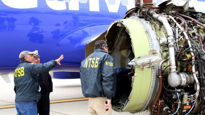 Investigators examine damage to the CFM International 56-7B turbofan engine belonging to Southwest Airlines Flight 1380 that separated during flight on April 17, 2018