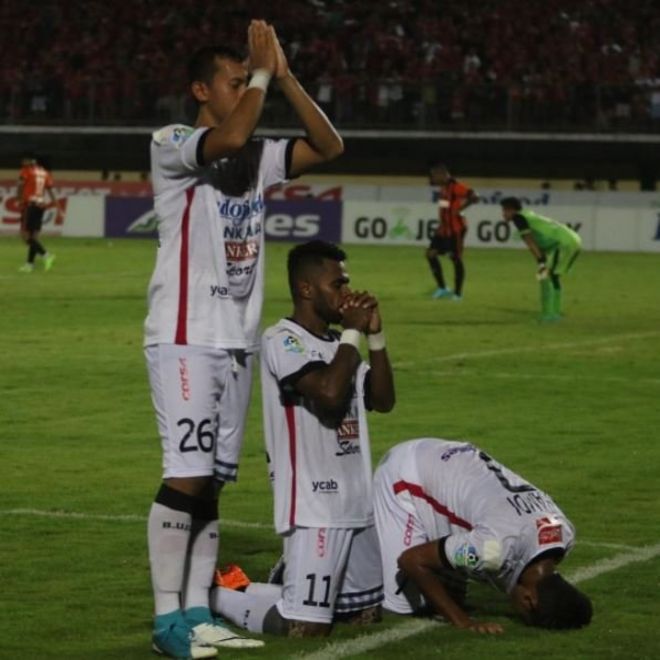 Footballers for Bali United FC assume three different prayer positions