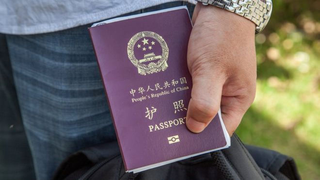 A Chinese national holds a Chinese Passport after entering Cambodia (May 2014)