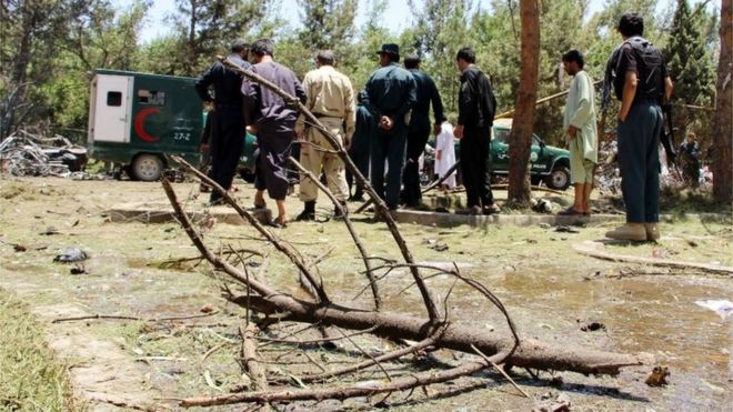 Afghan security officials inspect the site of a suicide bomb blast near the Kabul Bank branch in Lashkar Gah, capital of Helmand province, Afghanistan, 22 June 2017.