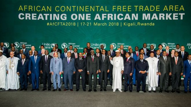 44 African heads of state lined up in three rows against a background which reads "African continental free trade area, creating one African market. #AfCFTA2018 17-21 March 2018, Kigali, Rwanda."