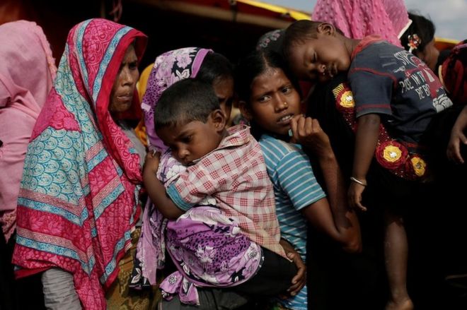 Rohingya refugees line up for a food supply distribution at the Kutupalong refugee camp near Cox's Bazar, Bangladesh 12 December 2017.