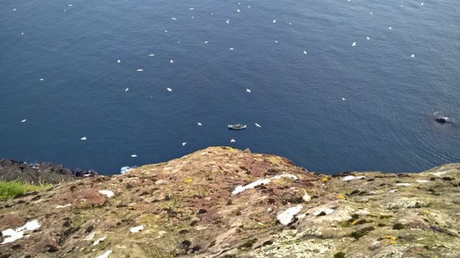 boat at bottom of cliff