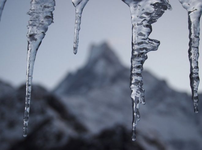Icicles in front of a landscape