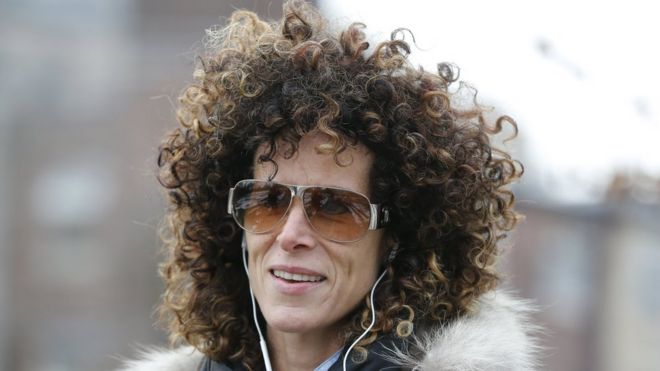 Andrea Constand walks in a park wearing headphones and with headphones in her ears in Toronto, December 30, 2015.